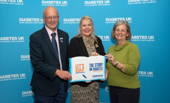 Martin Emmerson, Mims Davies MP and Caroline Cross holding a sign saying 'let's rewrite the story on diabetes'