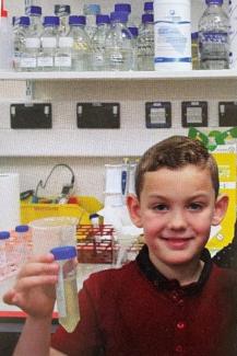 Boy in lab holding a test tube