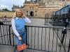 Imogen poses and smiles next to a castle in the background.