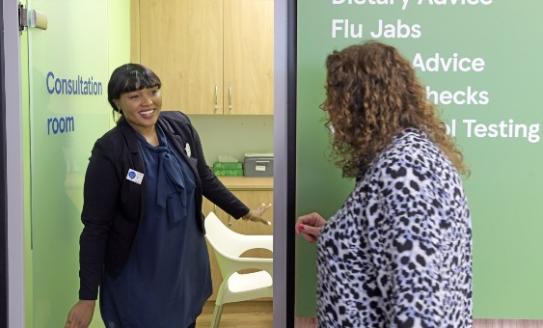 A Tesco pharmacist greeting patient 