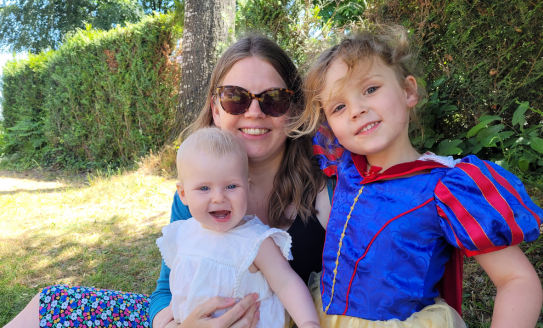 Mother with two young children outside 