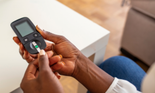 Woman hands using lancet on finger to check blood sugar level